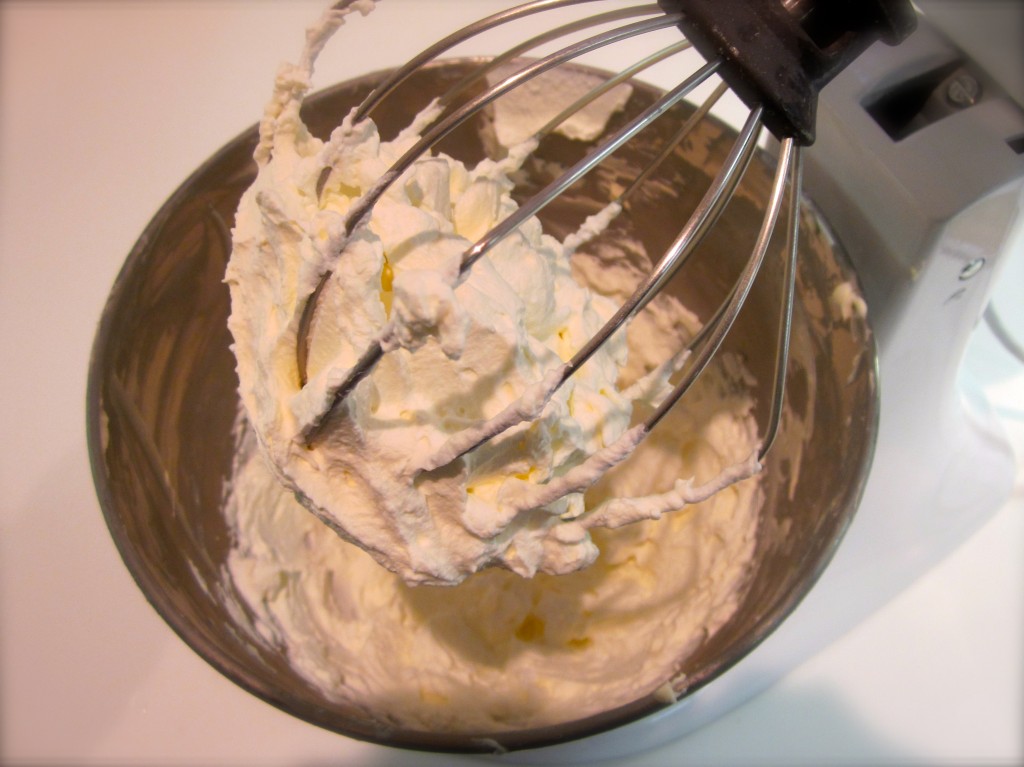 After beating cream cheese, confectionary sugar, salt and vanilla to a smooth and velvety texture,  we set  it aside. We whipped heavy cream until it began to hold firm peaks. (pictured here). 