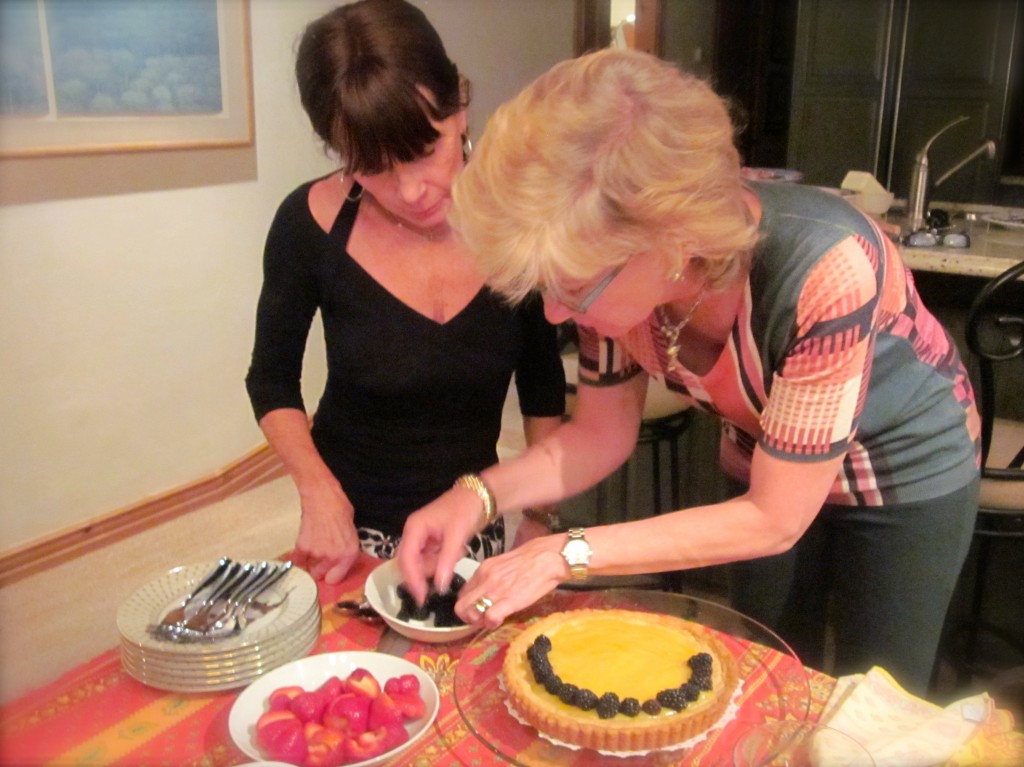 Ann rings the tart with blackberries.