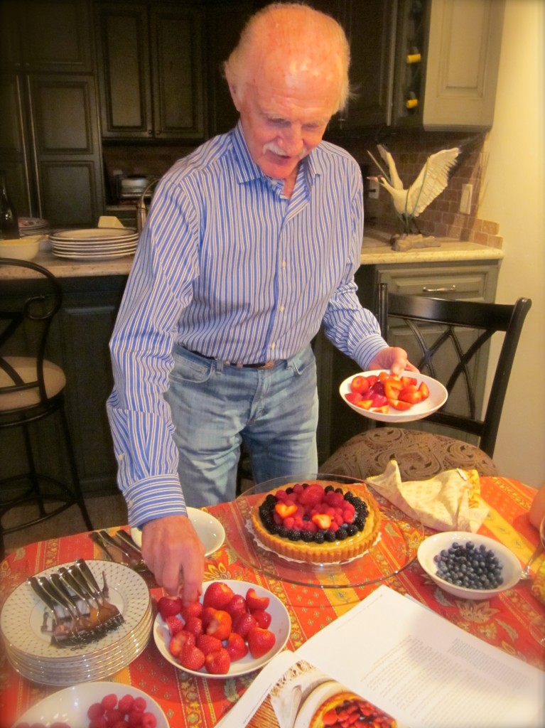 Gene puts both whole strawberries and halved berries on the tart.
