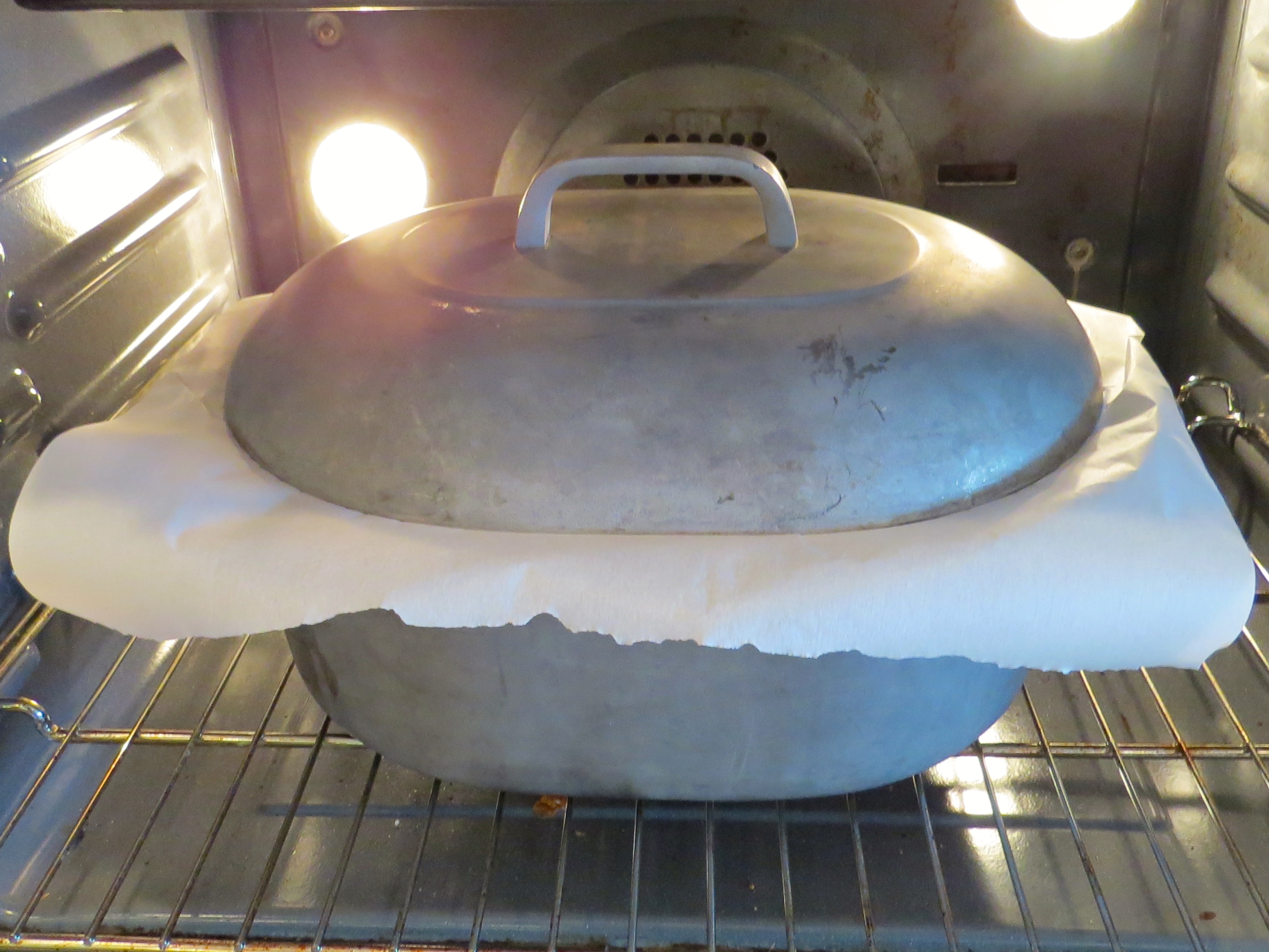 Dorie suggests putting parchment paper between the pan and the lid to keep the liquids from evaporating. A new technique that worked.