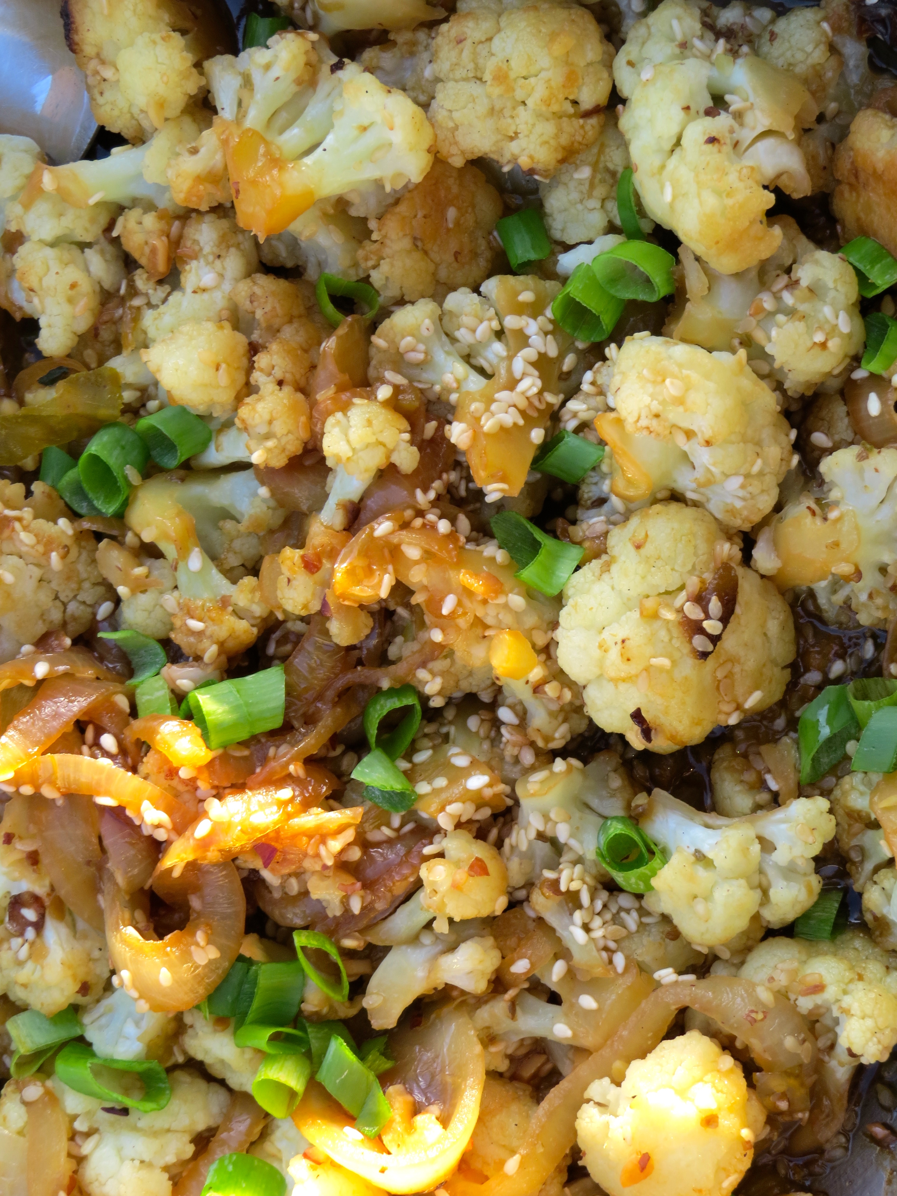 Stir-fried Sesame Cauliflower, a strongly seasoned side dish with chile, garlic and ginger.