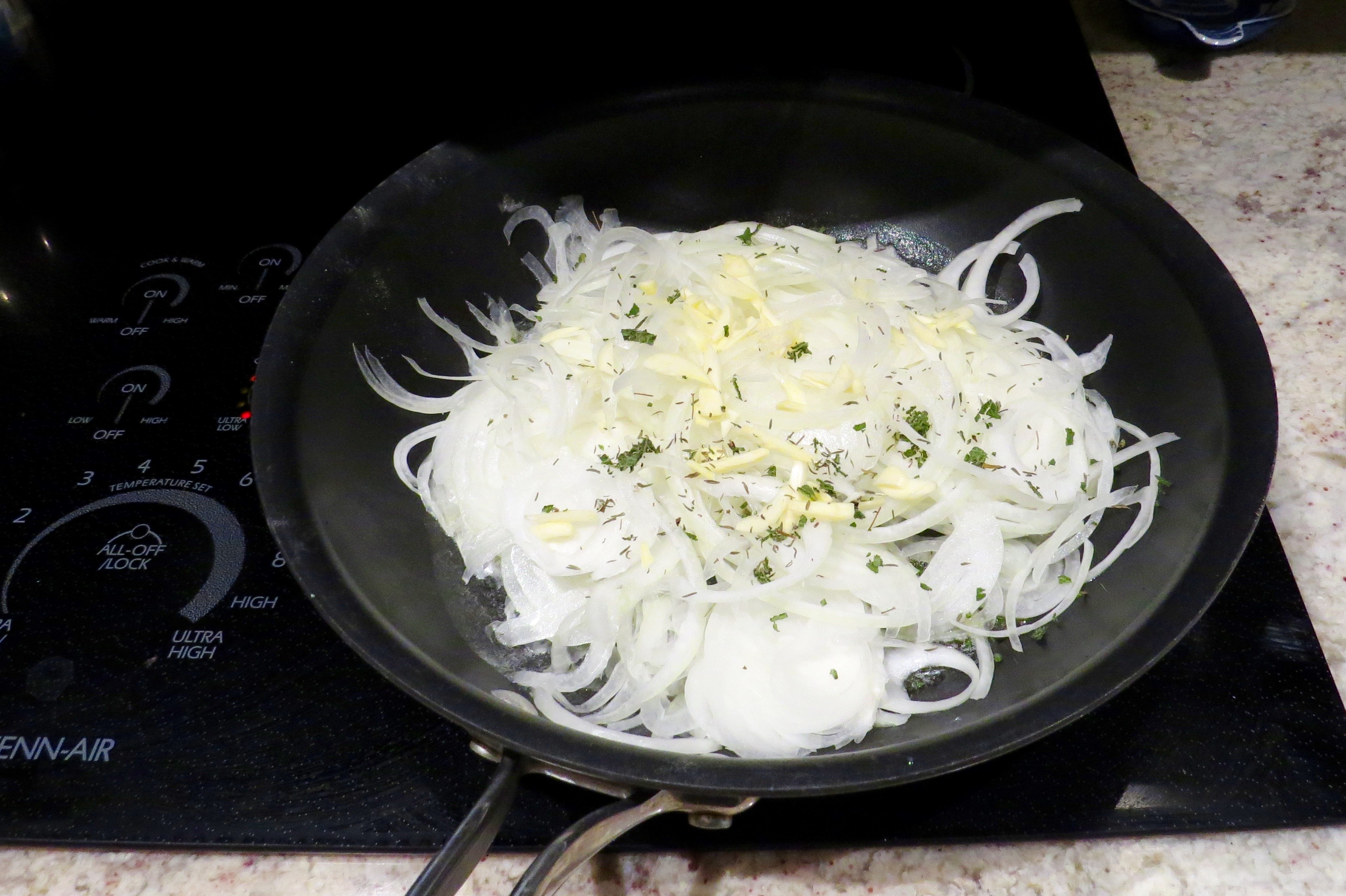 AFTER MELTING BUTTER WITH OLIVE OIL IN THIS PAN, I ADDED ONIONS, GARLIC AND HERBS TO COOK FOR 25-35 MINUTES. 