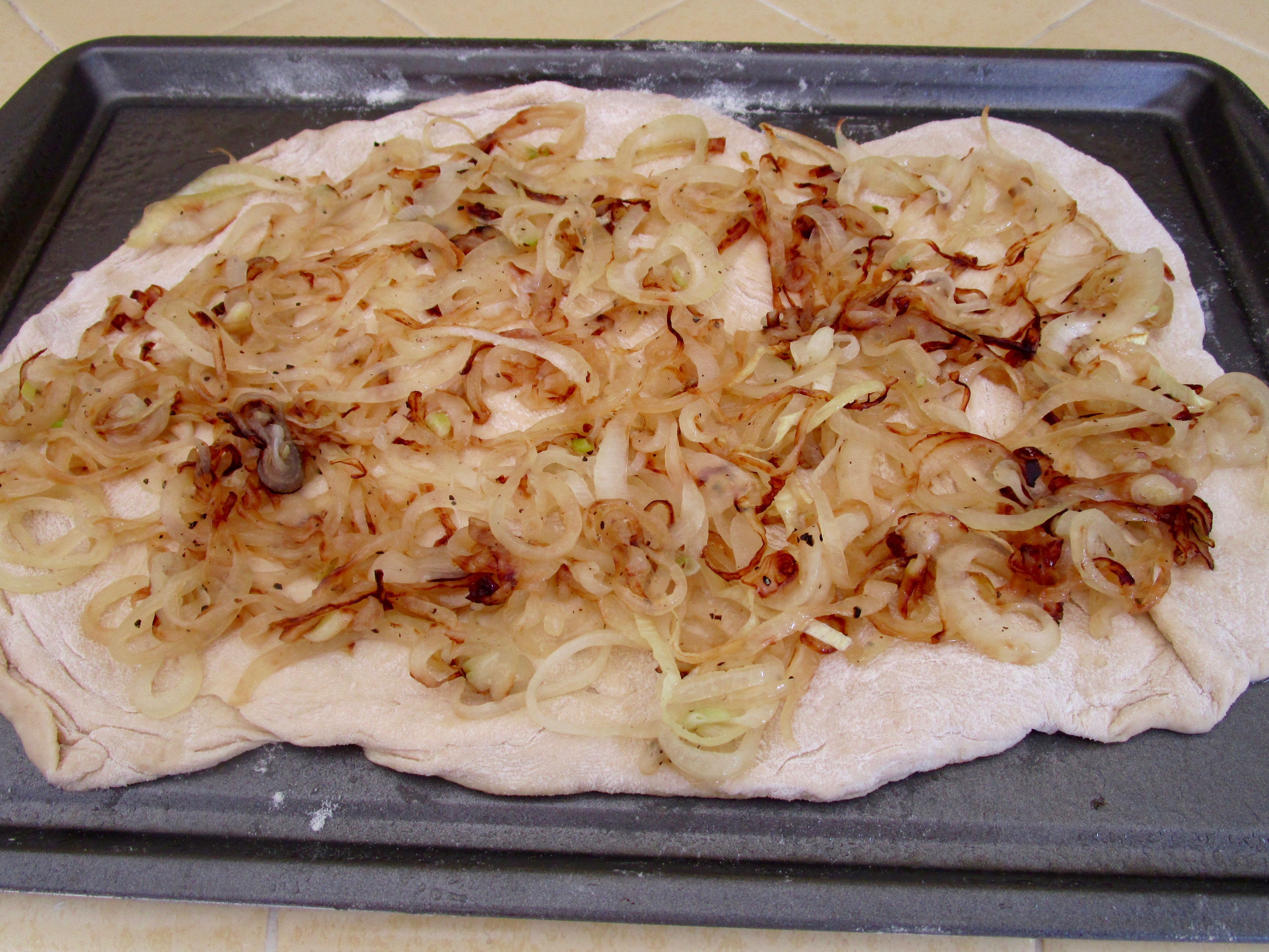 The softened, caramelized  sliced onions are this pizza's "sauce".
