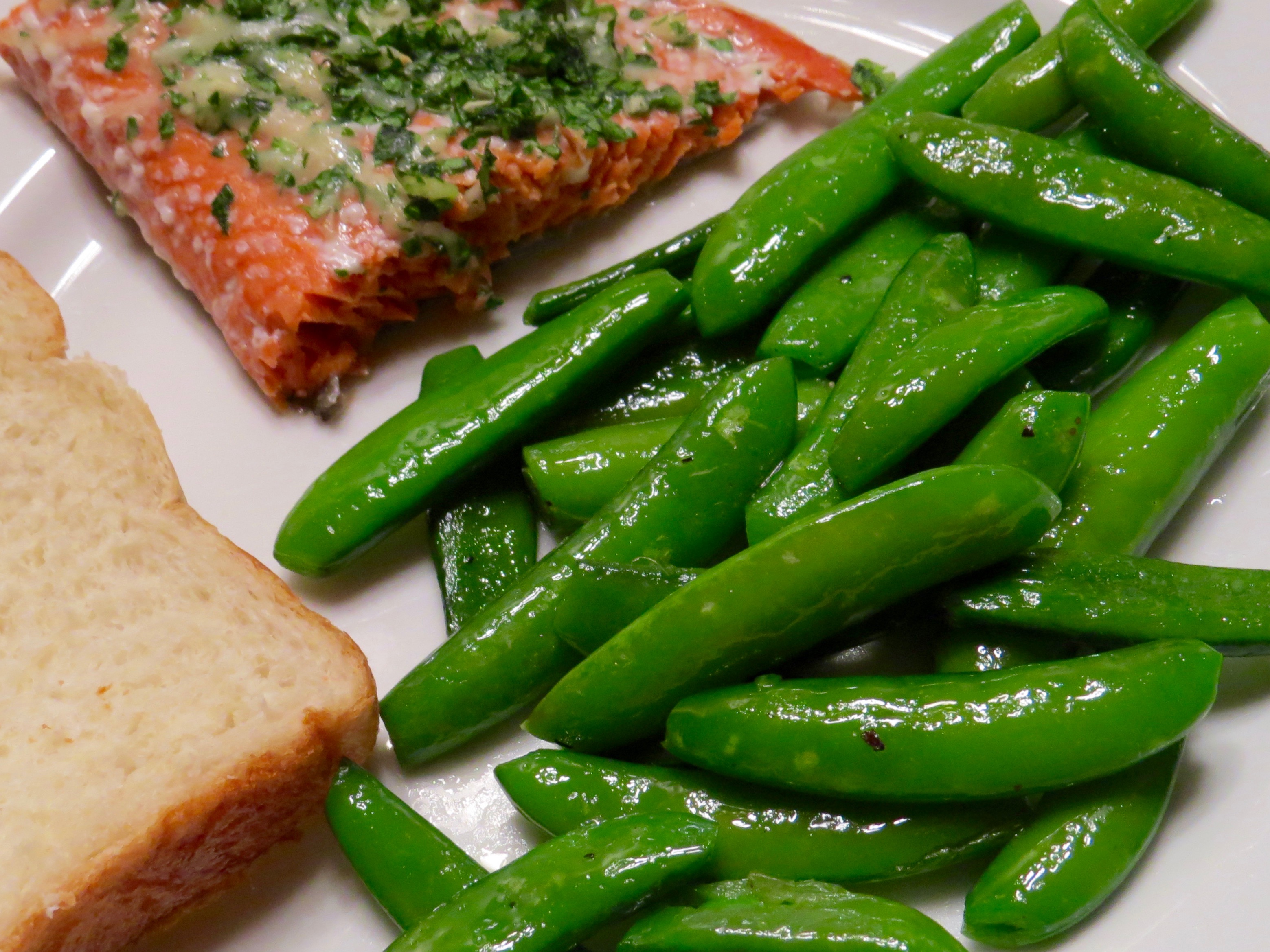  BAKED SALMON WITH PARMESAN HERB CRUST, SAUTEED SUGAR SNAP PEAS AND HOMEMADE BREAD.