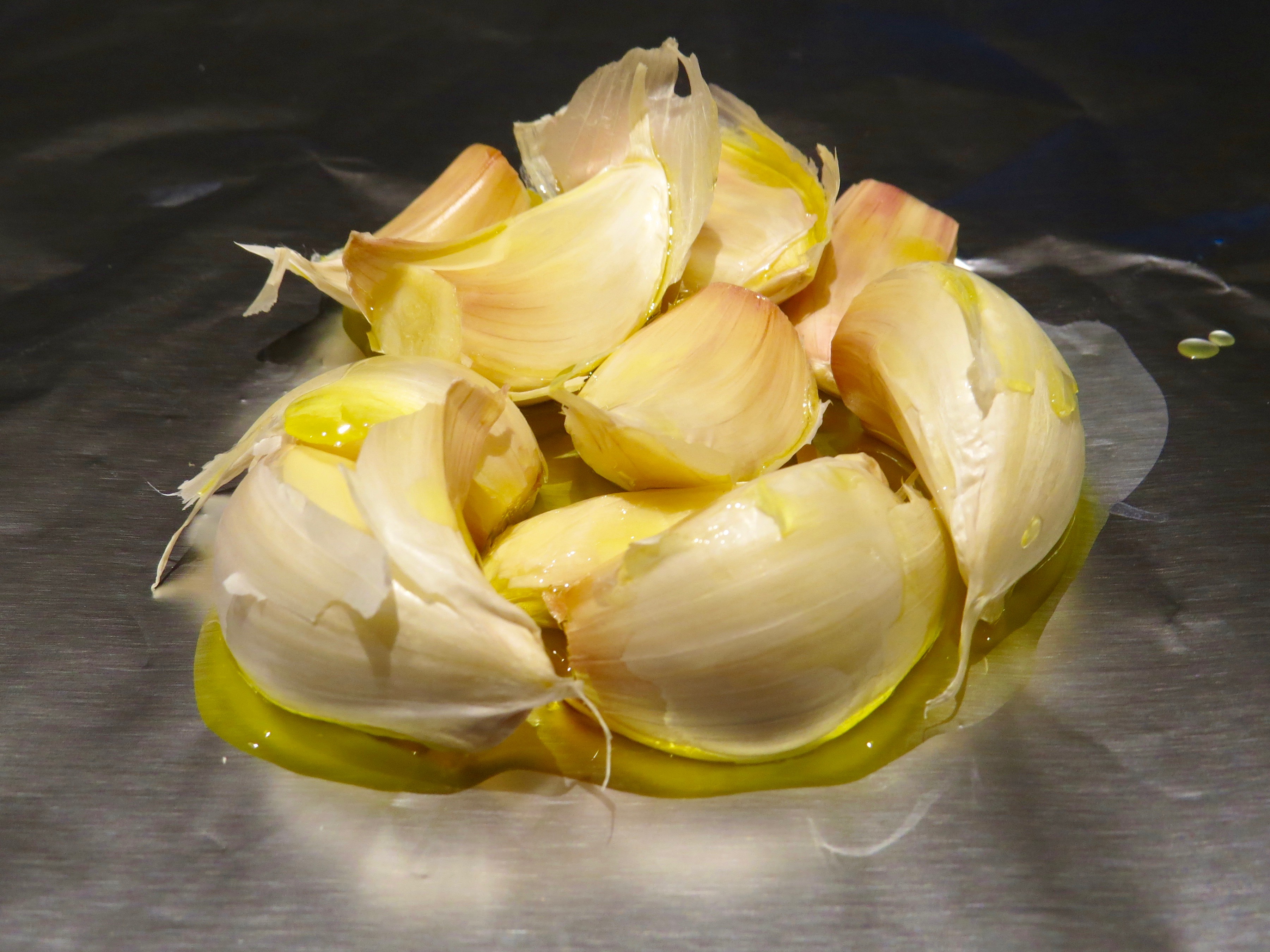 Popping some garlic cloves into the oven, ready to roast. The aroma is sublime.